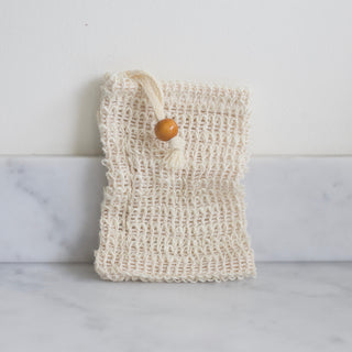 Natural sisal soap saver pouch draining a bar of handmade soap