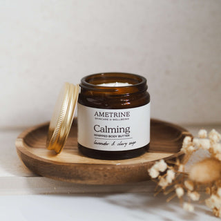 Jar of Ametrine Calming Body Butter with a spoon of the whipped texture